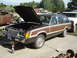 1984 Ford LTD - Station wagon with wood paneling and hood open, parked next to another vehicle.
