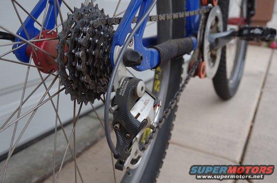 Rear derailleur and cassette on a blue bicycle frame