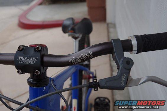 Close-up of bicycle handlebars with 'Truvativ Hussefelt' and 'TellBent' visible