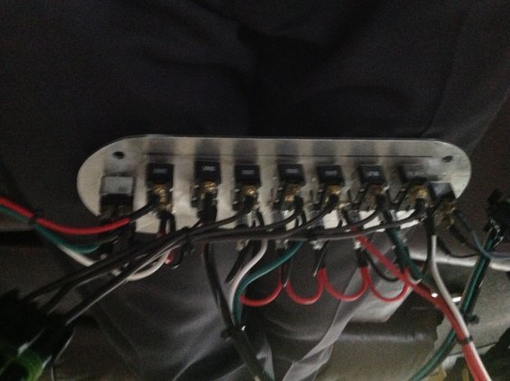Custom switch panel with multiple toggle switches and wiring harness attached