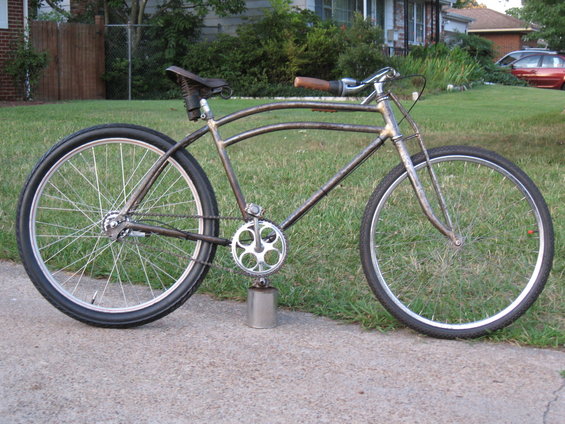 Side view of a custom cruiser bicycle with a weathered frame and large wheels