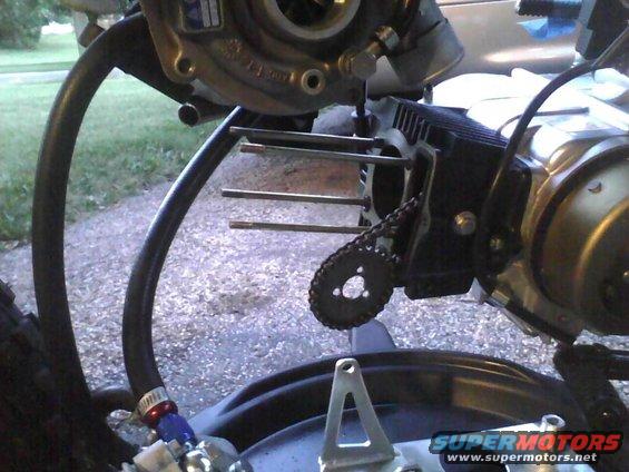 Motorcycle engine part with chain and bolts