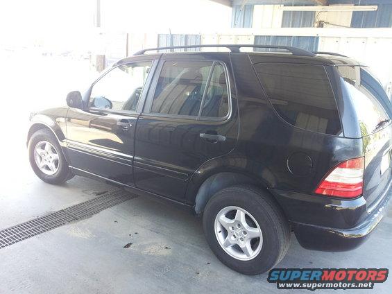 Black 2000 Mercedes-Benz ML-Class SUV, rear three-quarter view, parked indoors