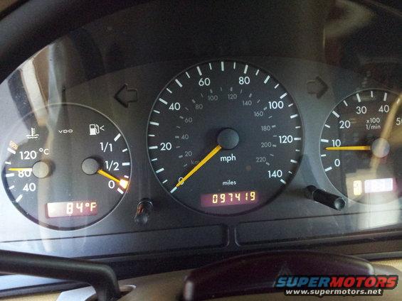 Dashboard gauges showing speed, RPM, fuel level, engine temperature, and 97419 miles. Also displays 84°F