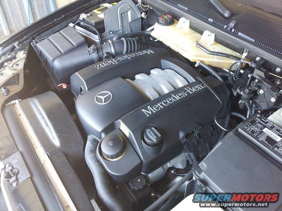 Mercedes-Benz engine bay with V-shaped engine cover and air intake system