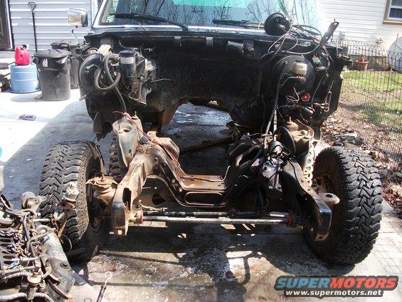 1990 Ford Bronco chassis with engine removed, front wheels attached