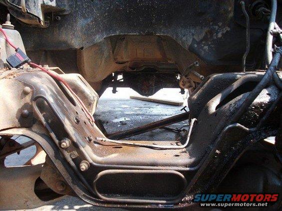 Undercarriage view of a vehicle frame with visible suspension components and drivetrain