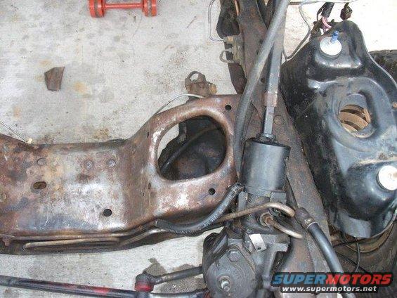 Rusted vehicle frame section with steering gear and hoses