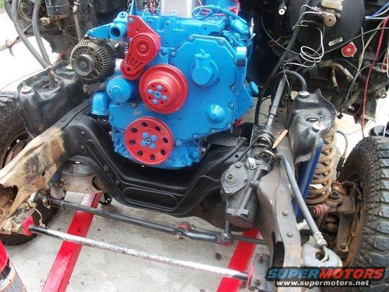 Blue and red engine installed in vehicle chassis