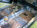 1975 Chevrolet Chevelle - The floor of this car interior is heavily rusted and damaged, with the original carpet missing.