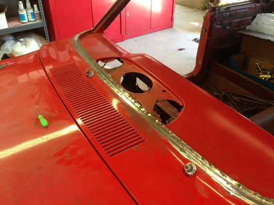 Red car hood and cowl area with louvers and holes for windshield wipers