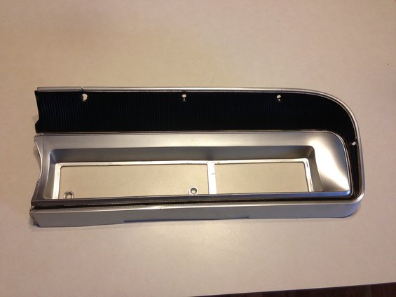 Silver dashboard trim with black ribbed insert and two rectangular openings