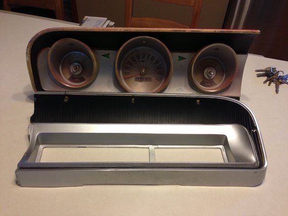 1964 Ford Fairlane instrument cluster with three gauges and chrome trim