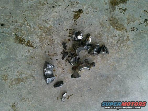 Pile of broken engine bearings on a concrete floor