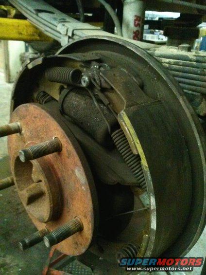Rusty brake drum assembly with visible springs and brake shoes
