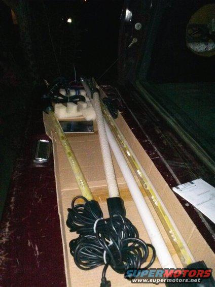 Interior of a vehicle with fluorescent lights and wires in a cardboard box