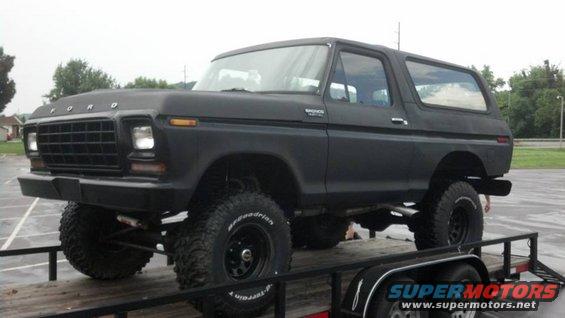 Black lifted 1979 Ford Bronco 3/4 front view on trailer