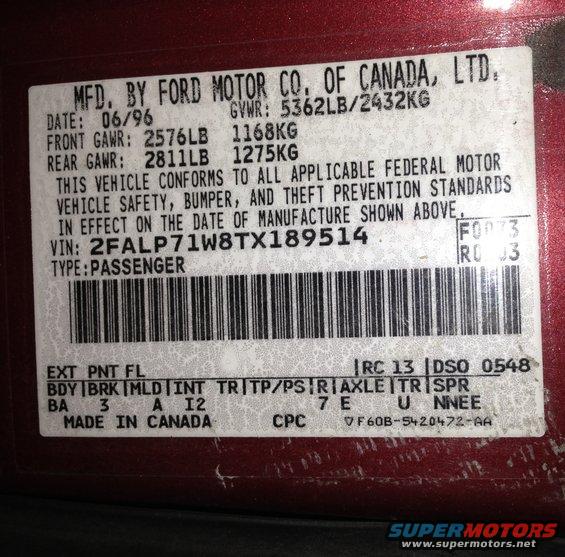 Close-up of a Ford vehicle identification label with manufacturing date 06/96 and VIN 2FALP71W8TX189514