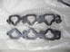 1993 Mazda MX-3 - A pair of intake manifold gaskets, one showing signs of wear and tear, the other appearing new.