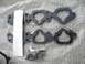 1993 Mazda MX-3 - Two intake manifold gaskets and a small bag of bolts are laid out on bubble wrap, with a partial sticker nearby.