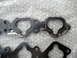 1993 Mazda MX-3 - Close-up of two engine gaskets, one showing signs of wear and tear, the other appearing new.