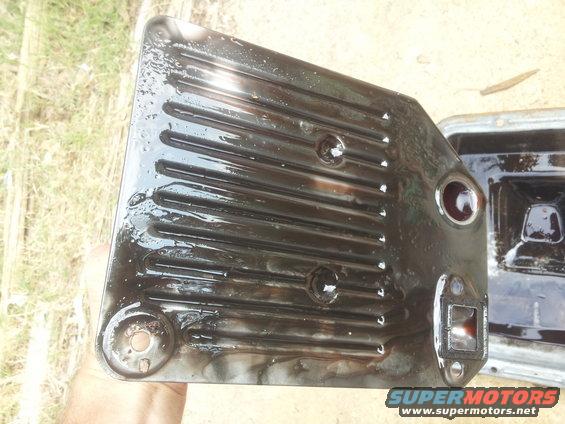 Transmission pan and filter covered in dark oil