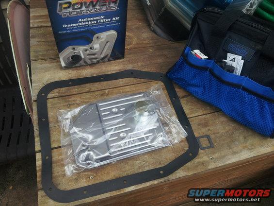 automatic transmission filter kit and gasket on wooden surface