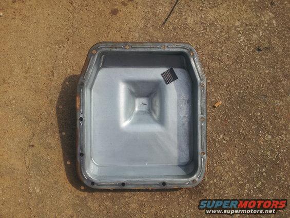 Transmission oil pan with a small square sticker on the inside