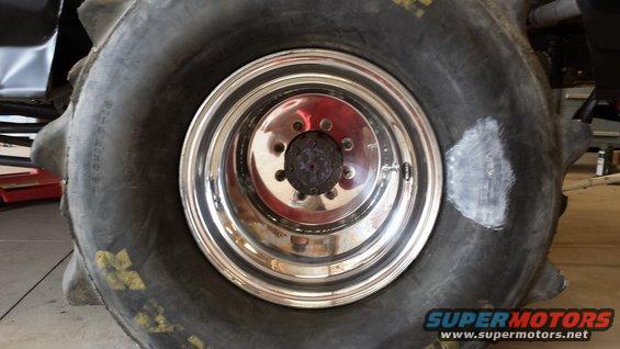 Close-up of a large off-road tire with a shiny chrome wheel