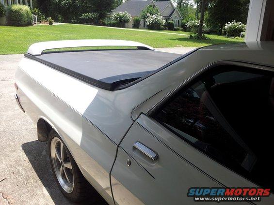 White pickup truck with tonneau cover and racing wheels