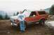 1983 Ford Bronco - A man poses with his red Ford Bronco in a mountainous, outdoor setting.