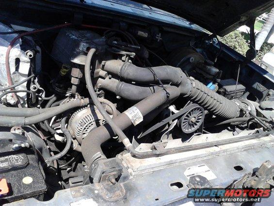 p82a0115.jpg everything all in and running. was rushing too much against a thunderstorm to take pics but nothing was of interest anyway. 

Its not pretty but it runs good. I didnt have time to get the fan shroud in. The 96 EGR tube broke so I put the 95 EGR tube in place but the system is different so its been blocked off and deleted a lot of emissions crap. I don't like my air filter setup but its the best I can do with my front clip swap. I did the Saginaw power steering pump swap and it was simple and is AMAZING! Due to my bent frame and front clip awap, I had to relocate my radiator up a few inches to clear the frame, I just welded some simple mounts up for it to bolt to. 

A/C box was replaced with one from a Ranger. It is smaller and needs quite abit of work to be done but my tire no longer destroys it and I can still have working A/C if I were to ever want to re-add it