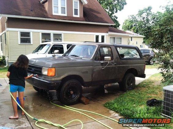 Gray 1987 Ford Bronco, 3/4 front view, being washed