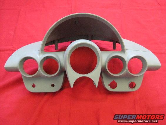 Gray dashboard instrument cluster with multiple circular gauge openings