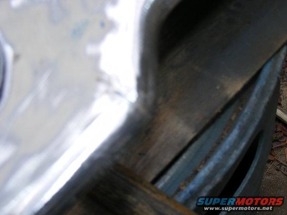 Close-up of a weathered metal component with visible texture and a watermark