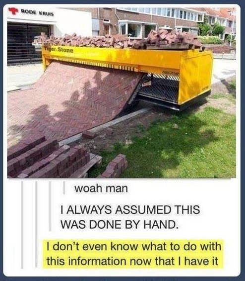 Yellow machine laying bricks, with a pile of bricks on top
