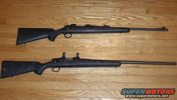 Two rifles with black stocks and long barrels lie on a wooden floor
