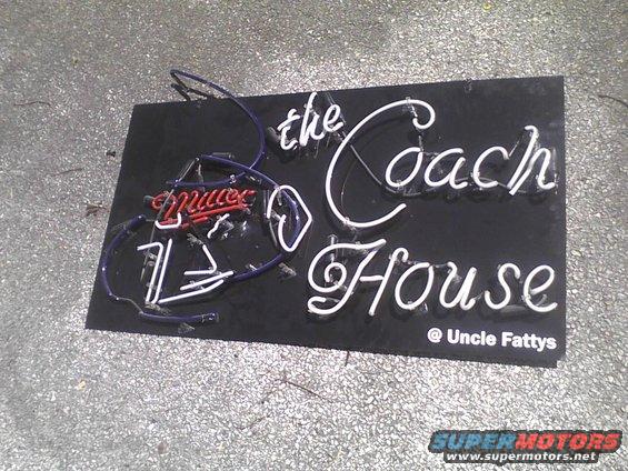 Broken neon sign that says "the Coach House" and "@ Uncle Fattys". Some red neon letters are also visible