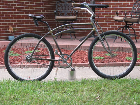 Custom cruiser bicycle with chrome frame and wide tires, side view