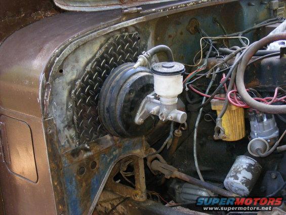 Engine bay showing brake booster and master cylinder