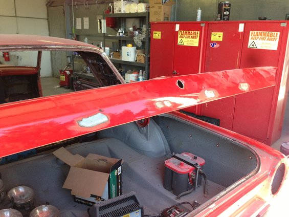 Red car trunk interior with dual batteries and charger