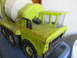 2004 Aston Martin Virage - This vintage toy cement mixer truck features a lime green body with visible rust and a white drum.