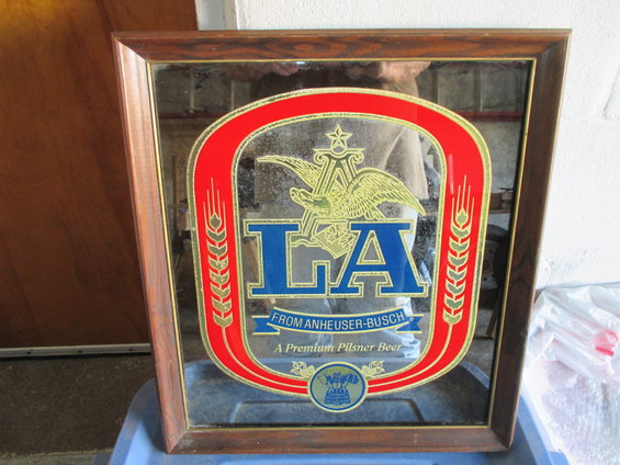 Wooden framed mirror with LA Anheuser-Busch logo and text 'A Premium Pilsner Beer'