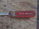 2004 Aston Martin Virage - A close-up view of a JCPenney brand screwdriver with a red handle.