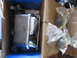 2004 Aston Martin Virage - A new brake master cylinder and other parts are shown inside their packaging.