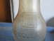 2004 Aston Martin Virage - Embossed text on a glass bottle indicates it is a one liquid quart container and has an O.H.B seal.