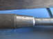 2004 Aston Martin Virage - Close-up of a tool handle showing a knurled grip and stamped text.