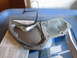 2004 Aston Martin Virage - A transmission pan, gasket, and filter are laid out on a document.