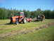1987 Ford F-250 - Tractor and hay trailer in a field on a sunny day.