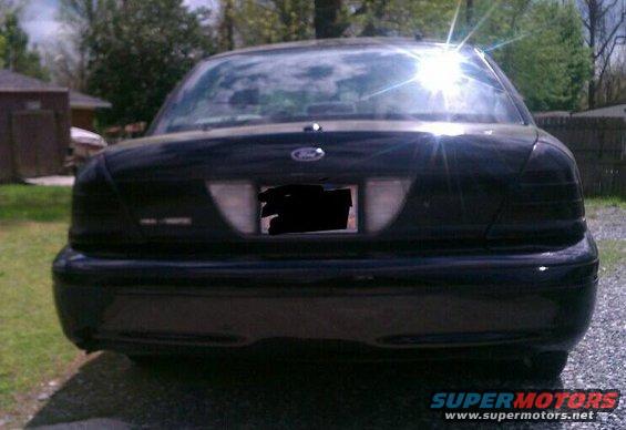 Black 2003 Ford Crown Victoria rear view, license plate obscured